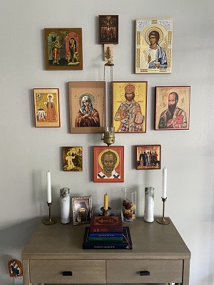Prayer corner with icons, Bible, candles, and incense